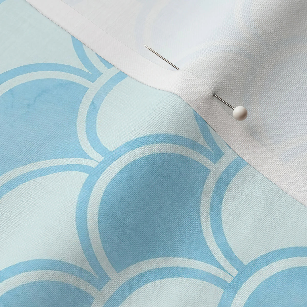 Pinned close-up of Scallop Waves fabric showing the white selvage margin