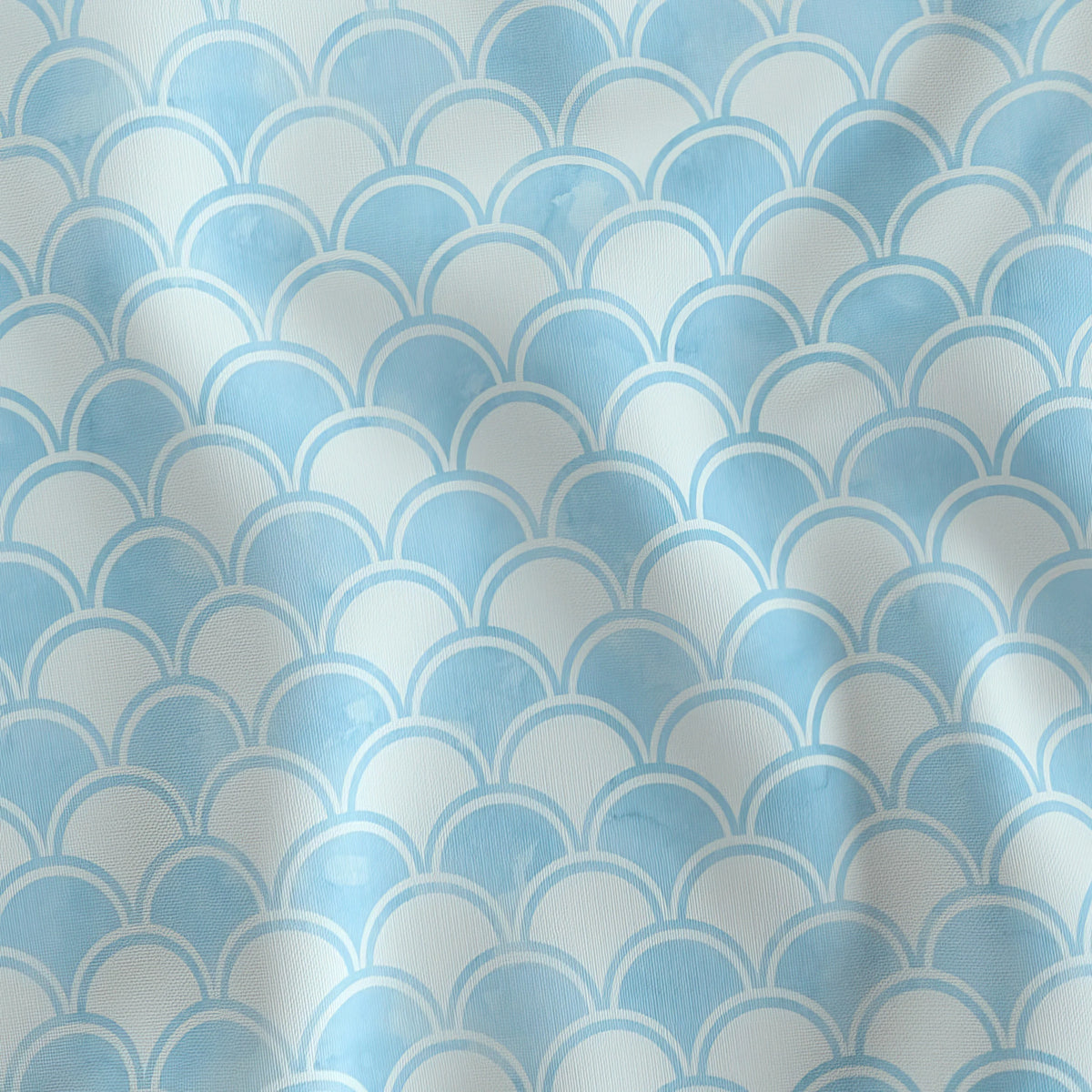 Scallop Waves blue watercolor wave quilting cotton draped to show the soft hand