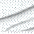 Whimsical Whale Anchors quilting cotton fabric draped close-up with a ruler showing true print scale
