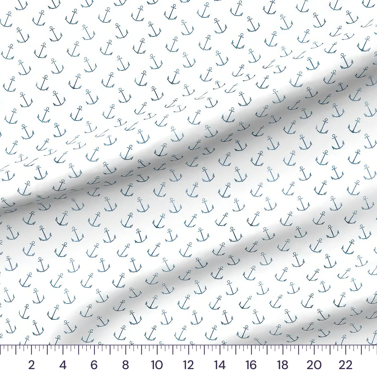 Whimsical Whale Anchors quilting cotton fabric draped close-up with a ruler showing true print scale