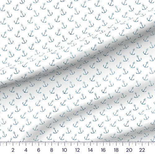 Whimsical Whale Anchors quilting cotton fabric draped close-up with a ruler showing true print scale