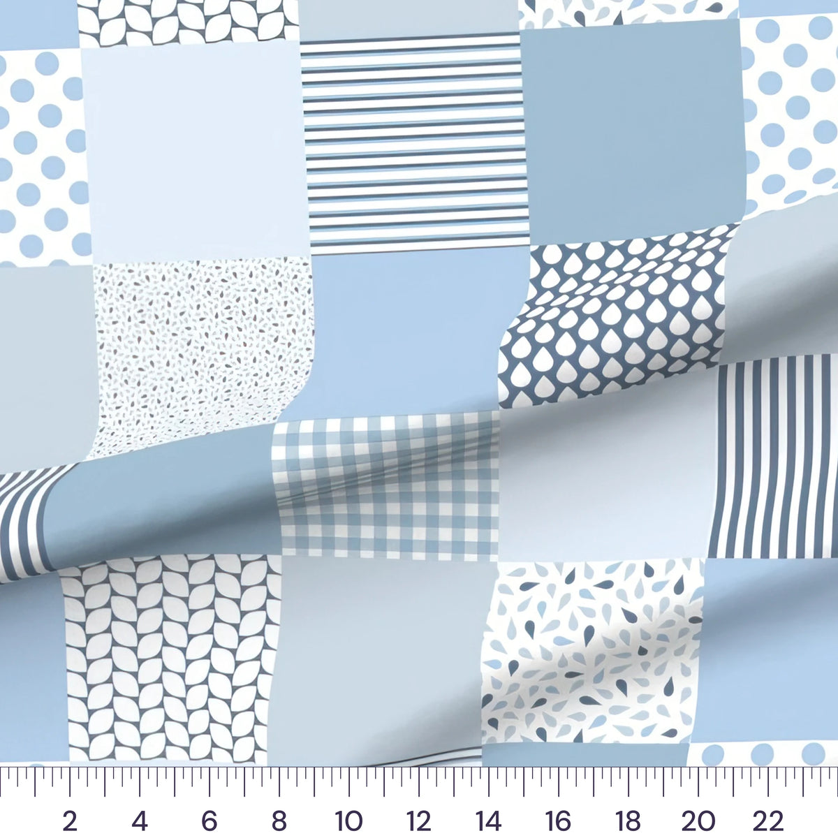Blue patchwork baby boy cheater quilt fabric by the yard with 6 inch blocks, draped quilting cotton with a ruler showing true scale