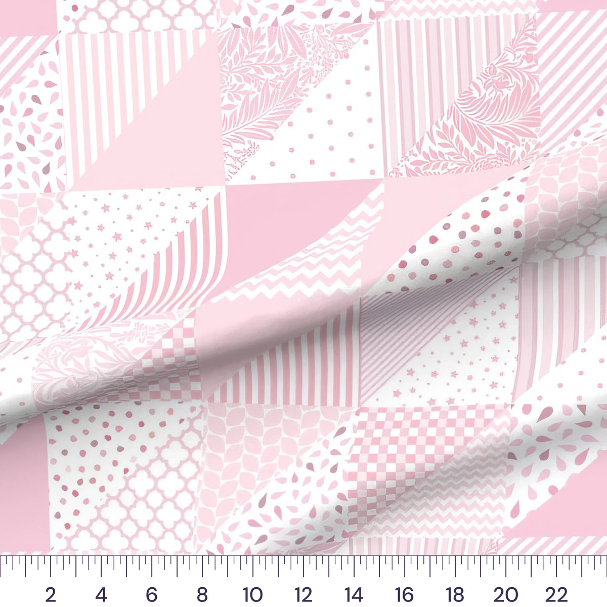 Pink patchwork baby girl cheater quilt fabric by the yard with 6 inch blocks, draped quilting cotton with a ruler showing true scale