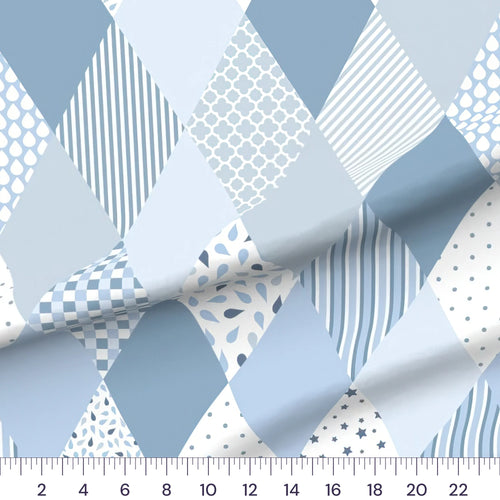 Blue diamond baby boy cheater quilt fabric by the yard with 6 inch blocks, draped quilting cotton with a ruler showing true scale