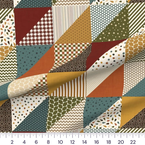 Autumn harvest cheater quilt fabric by the yard with 6 inch blocks, draped quilting cotton with a ruler showing true scale