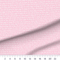 Baby Girl Script quilting cotton fabric – draped close-up with a ruler showing true print scale