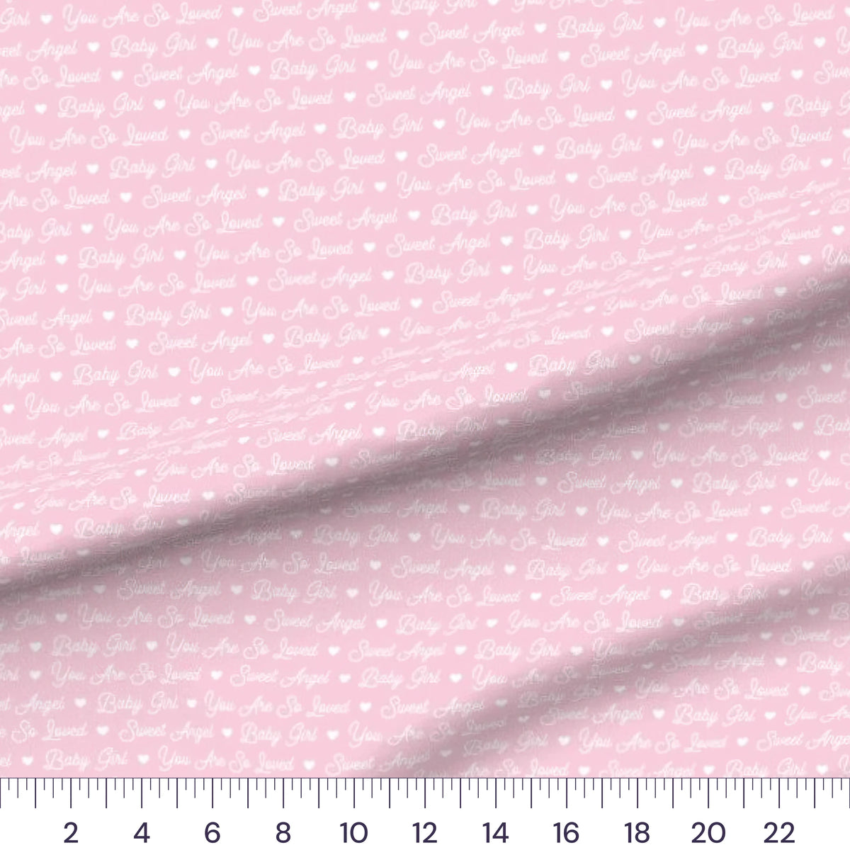 Baby Girl Script quilting cotton fabric – draped close-up with a ruler showing true print scale