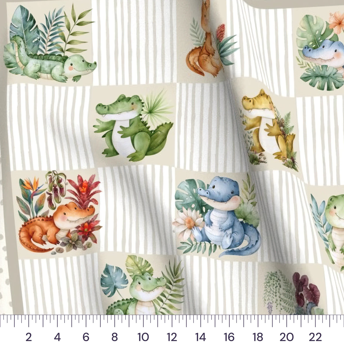Close-up of the Little Gator baby quilt panel with a ruler showing true scale