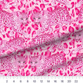 Hot Pink Leopard quilting cotton fabric – draped close-up with a ruler showing true print scale