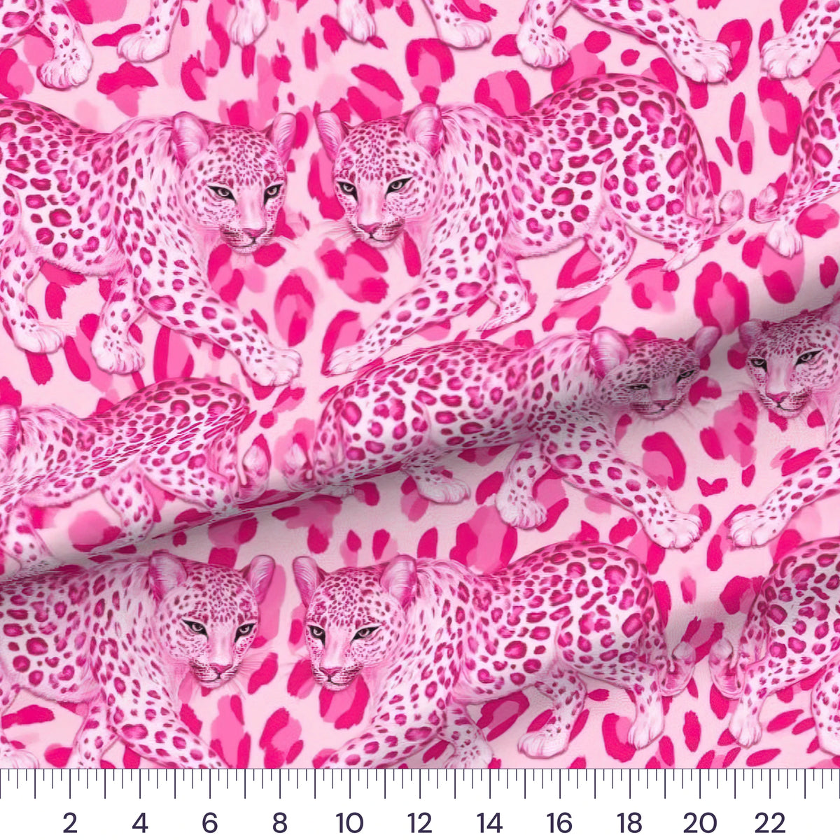 Hot Pink Leopard quilting cotton fabric – draped close-up with a ruler showing true print scale