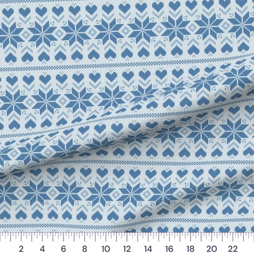 Blue Fair Isle quilting cotton fabric – draped close-up with a ruler showing true print scale