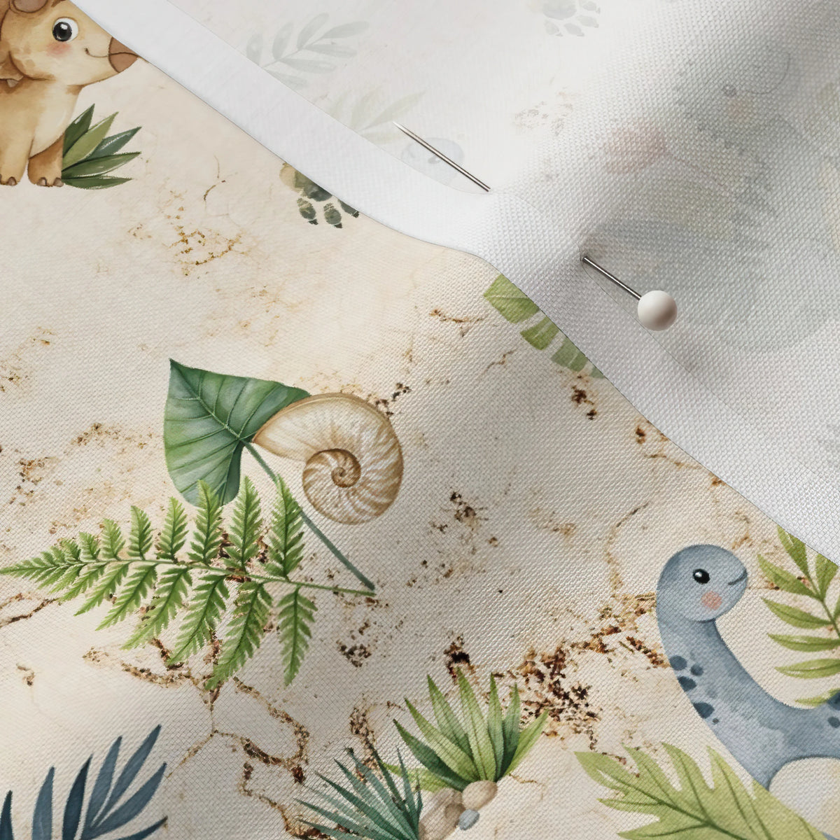 Pinned close-up of Dino Toss fabric showing the white selvage margin