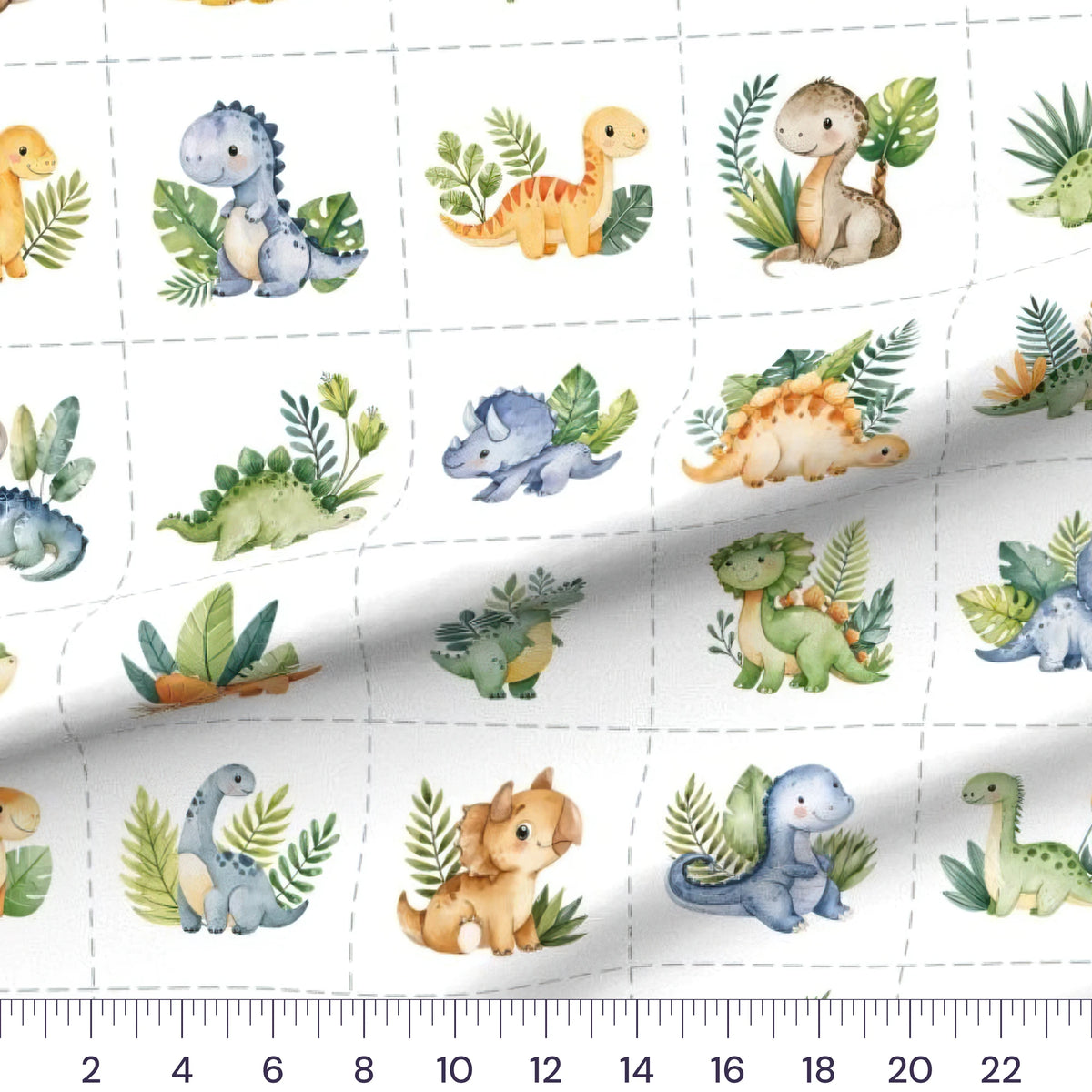 Baby Dinosaur Blocks quilting cotton fabric – draped close-up with a ruler showing true print scale