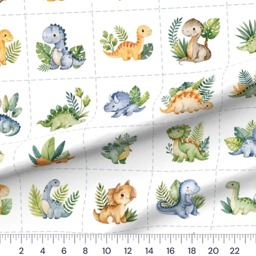 Baby Dinosaur Blocks quilting cotton fabric – draped close-up with a ruler showing true print scale