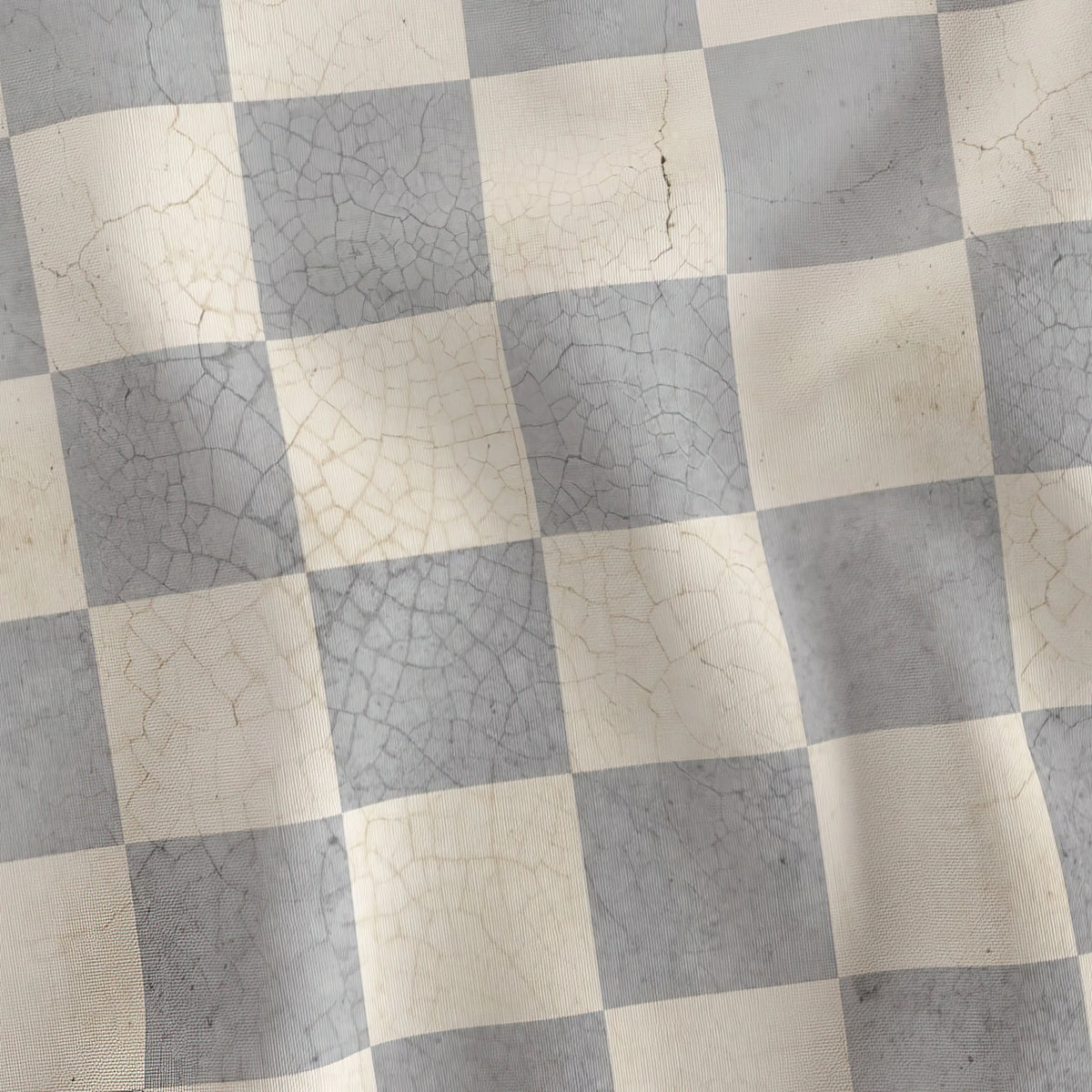 Gray and cream cracked-concrete checkerboard quilting cotton draped to show the soft hand
