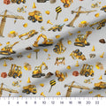 Little Diggers Toss quilting cotton close-up with a ruler showing the construction trucks at true scale