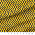 Caution Chevron yellow and black quilting cotton close-up with a ruler showing true scale