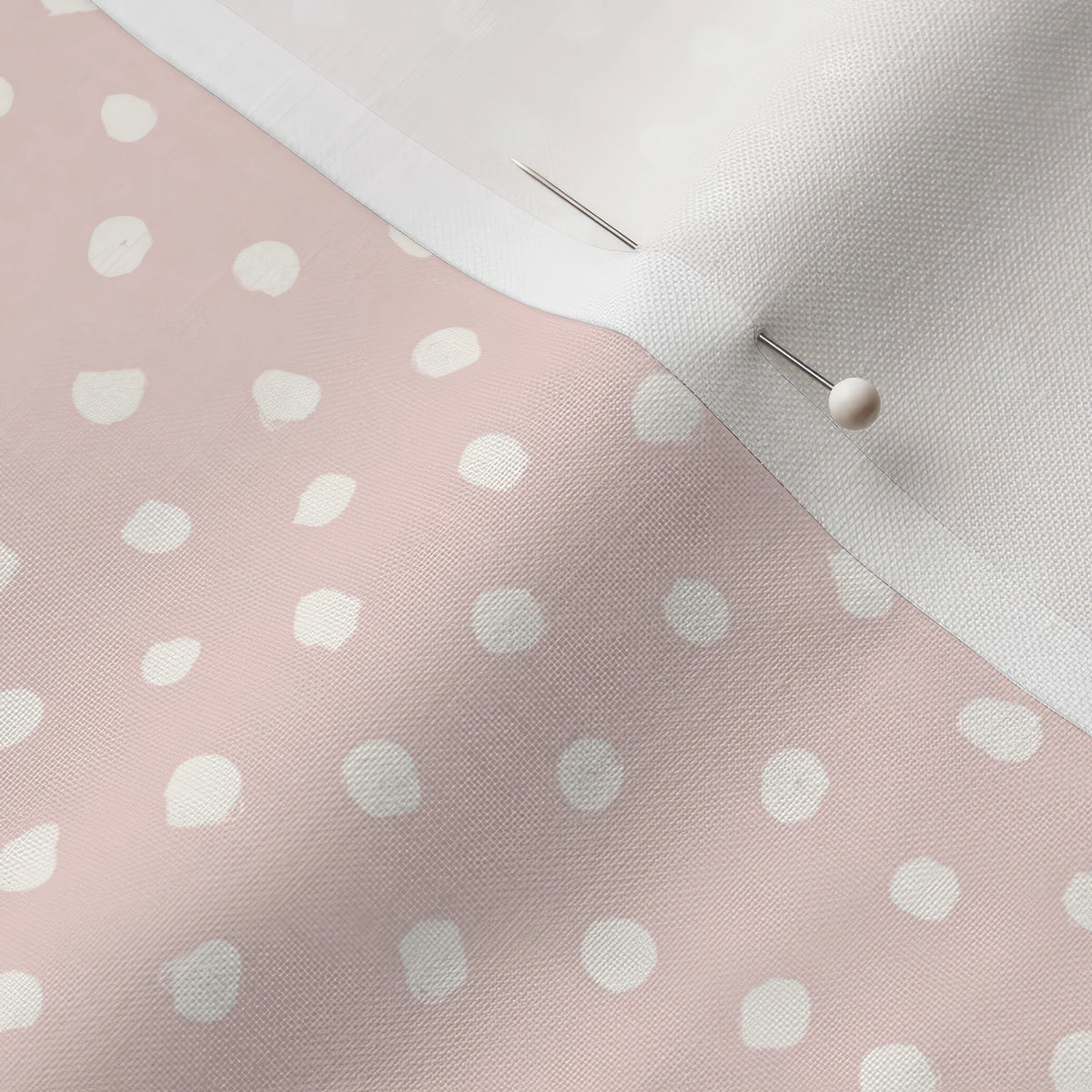 Pinned close-up of Petal Doodle Dots fabric showing the white selvage margin