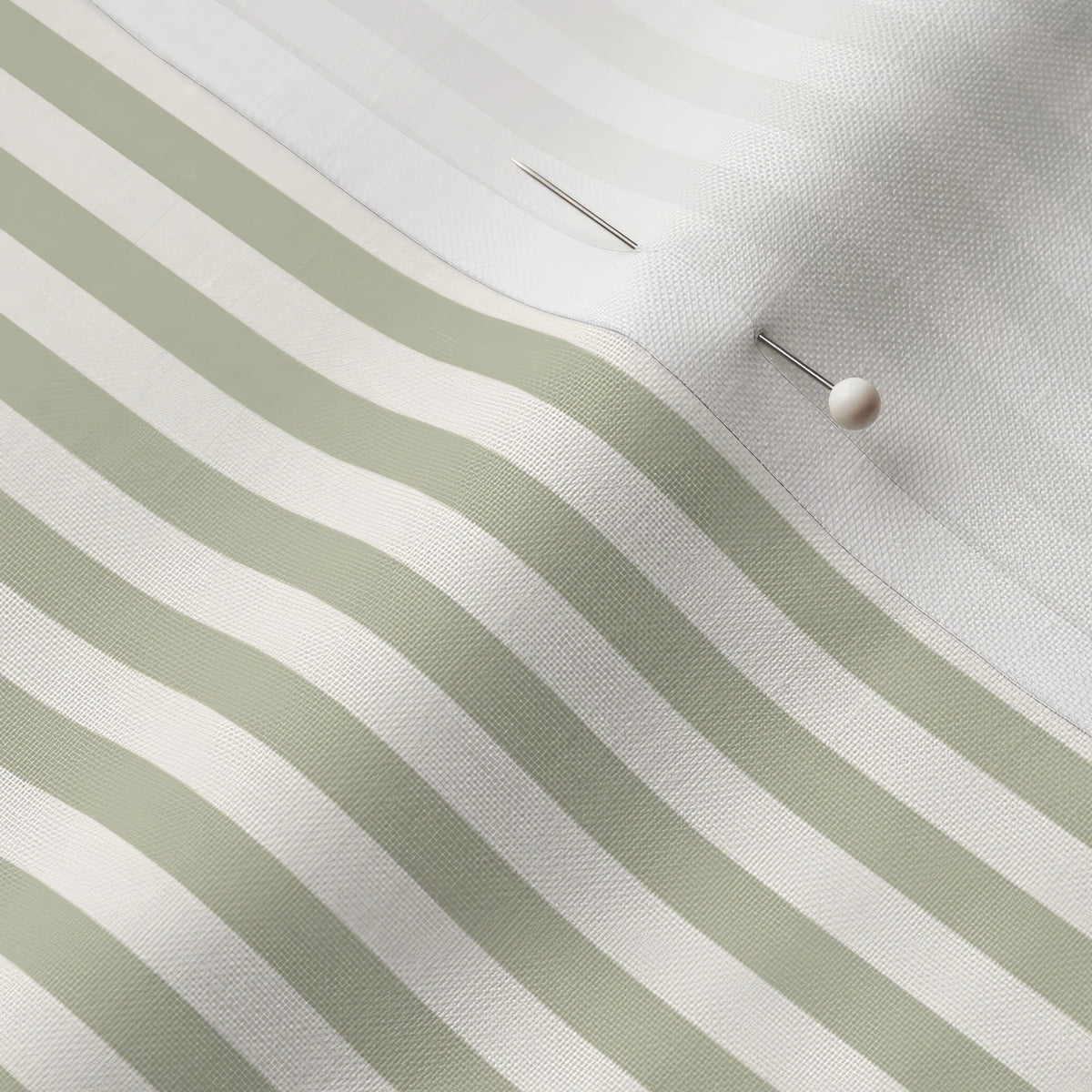 Pinned close-up of Sage 1/4 inch stripe fabric showing the white selvage margin
