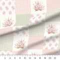Rosy Patchwork cheater quilt fabric close-up with a ruler showing the 6 inch blocks at true scale