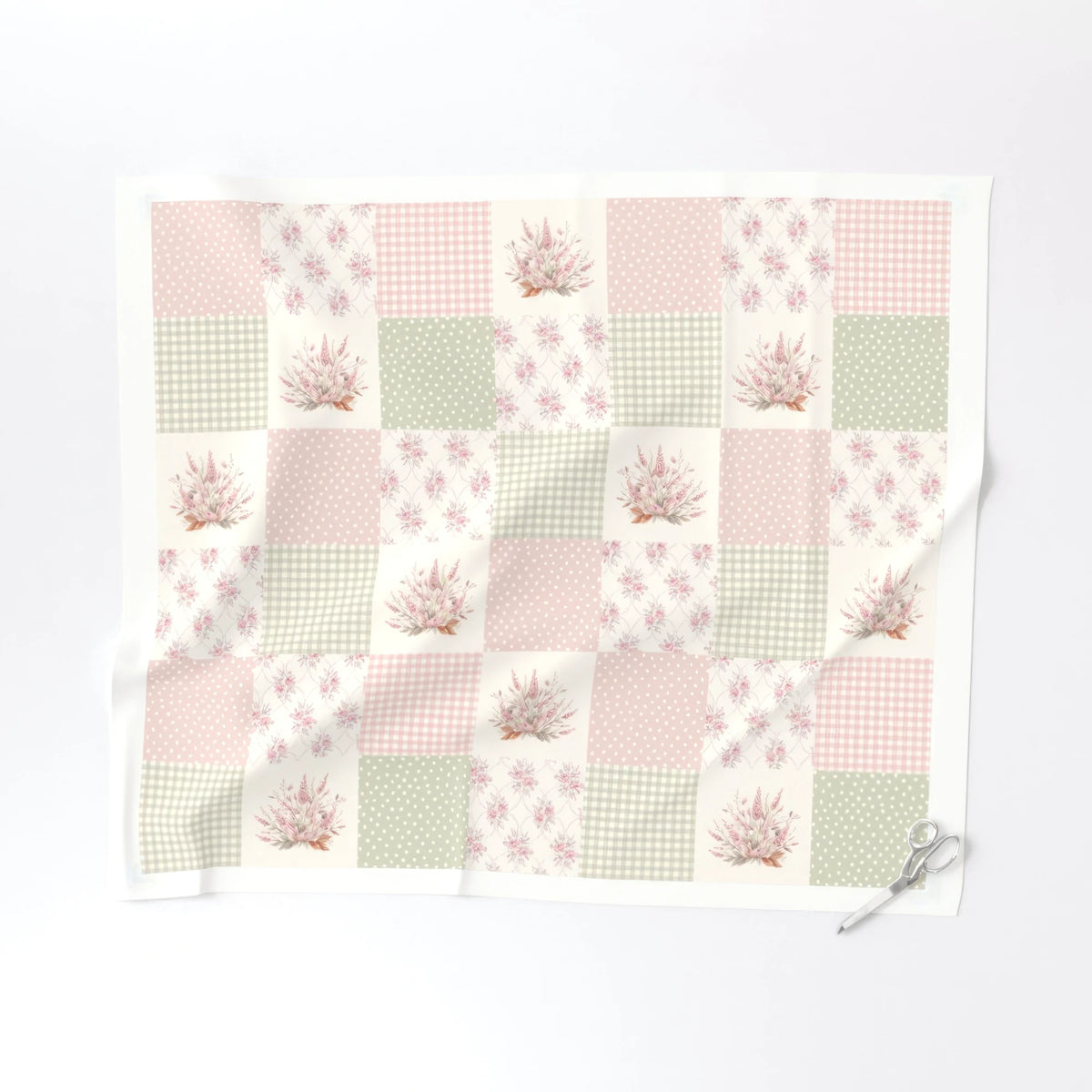 One yard of Rosy Patchwork cheater quilt fabric laid flat showing the 6 inch blush and sage blocks