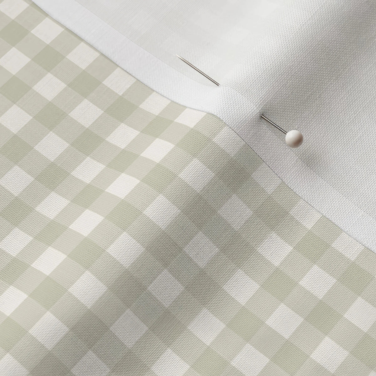 Pinned close-up of Sage Mini Gingham fabric showing the white selvage margin