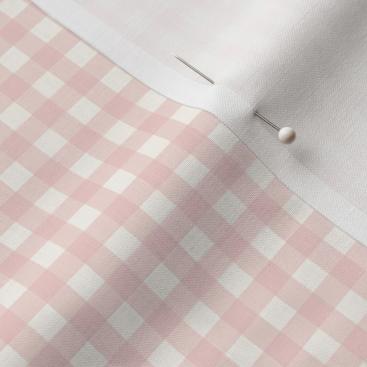 Pinned close-up of Rose Petal Mini Gingham fabric showing the white selvage margin