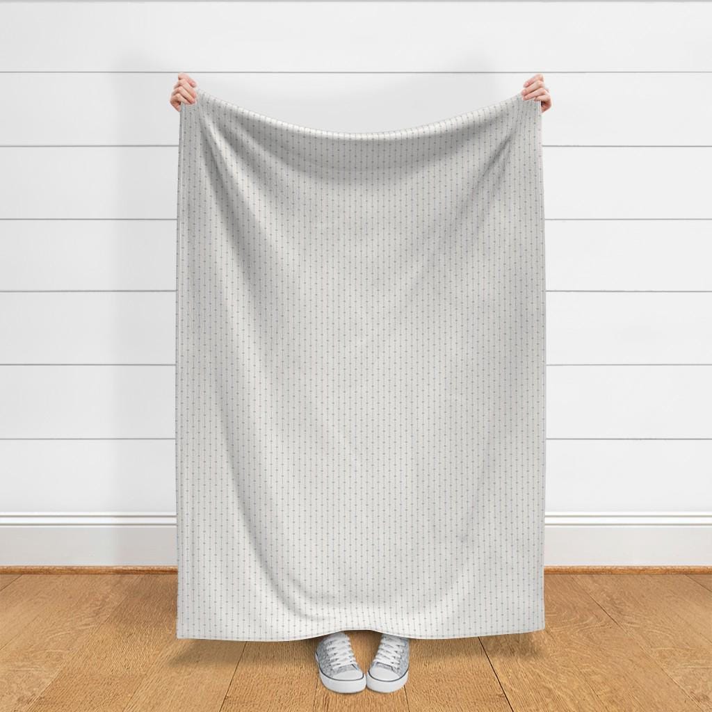 Full yard of Blue on Ivory ditsy star stripe fabric held up to show the size of one yard