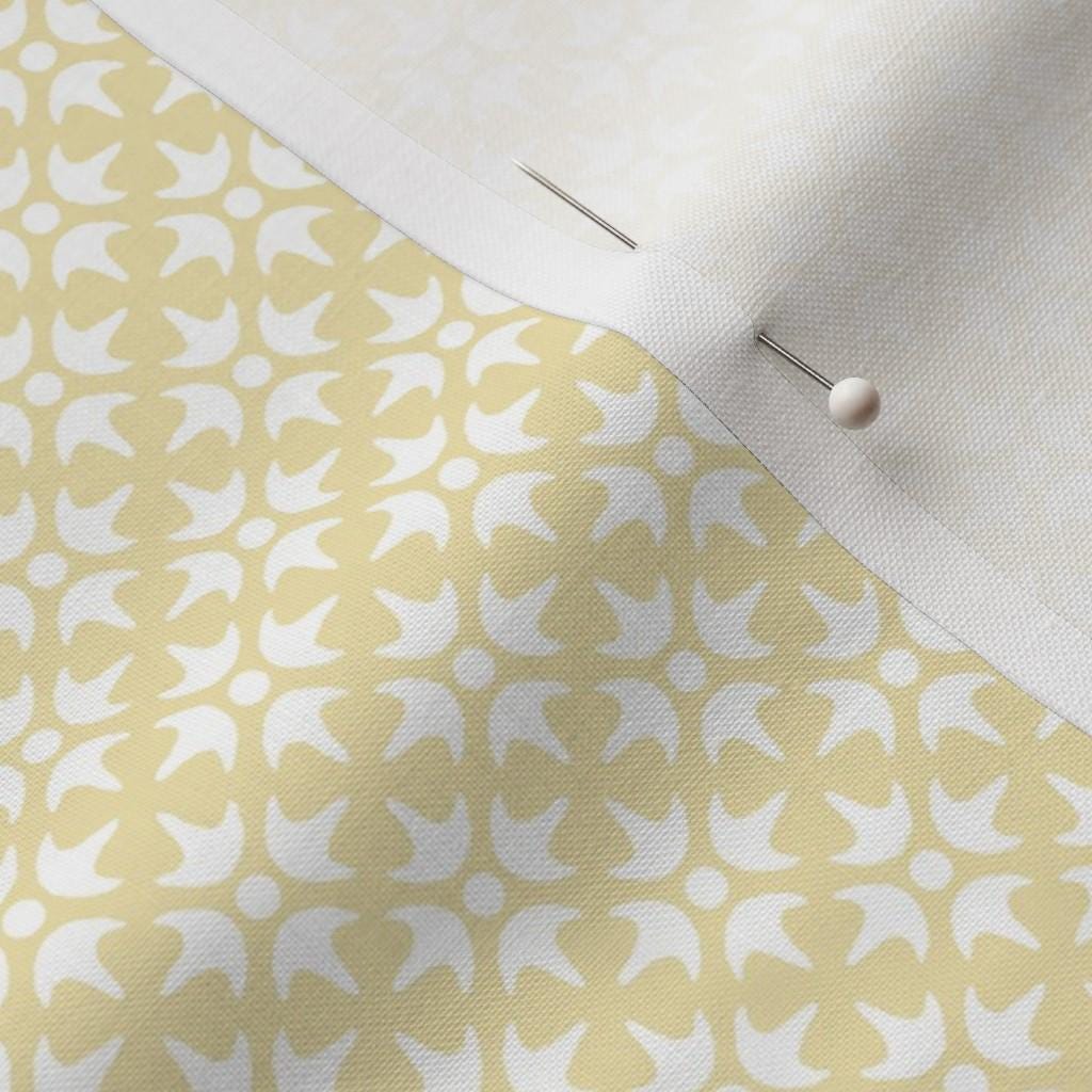 Pastel Yellow Thistle Star fabric showing the pastel yellow geometric lattice print on cotton quilting fabric