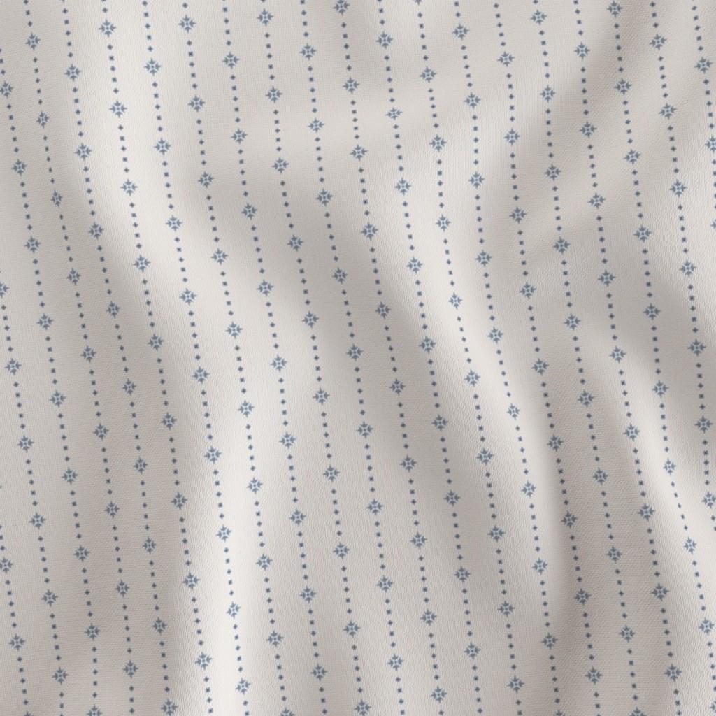 Blue on Ivory ditsy star stripe fabric draped to show the soft hand and soft blue star stripe on ivory print