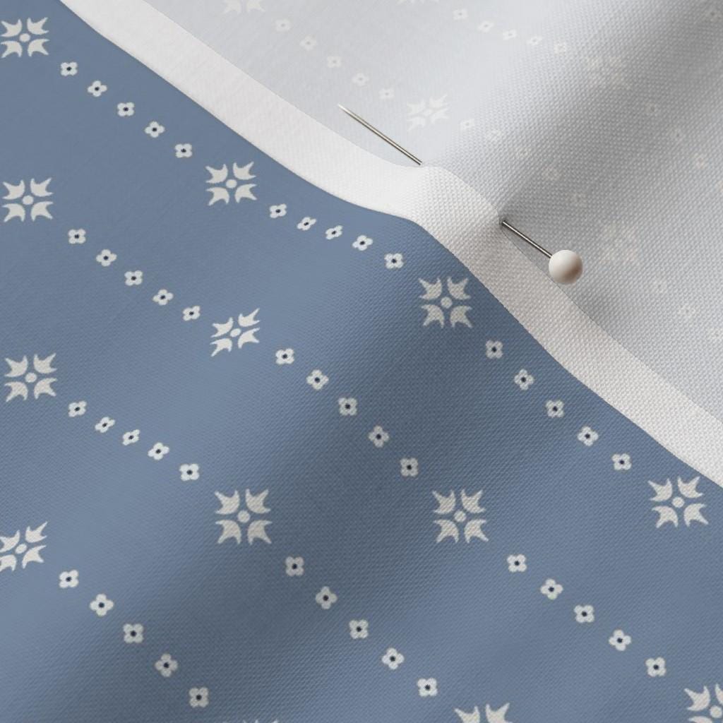 Ivory on Blue ditsy star stripe fabric close-up – ivory star stripe on a soft blue ground quilting cotton fabric by the yard