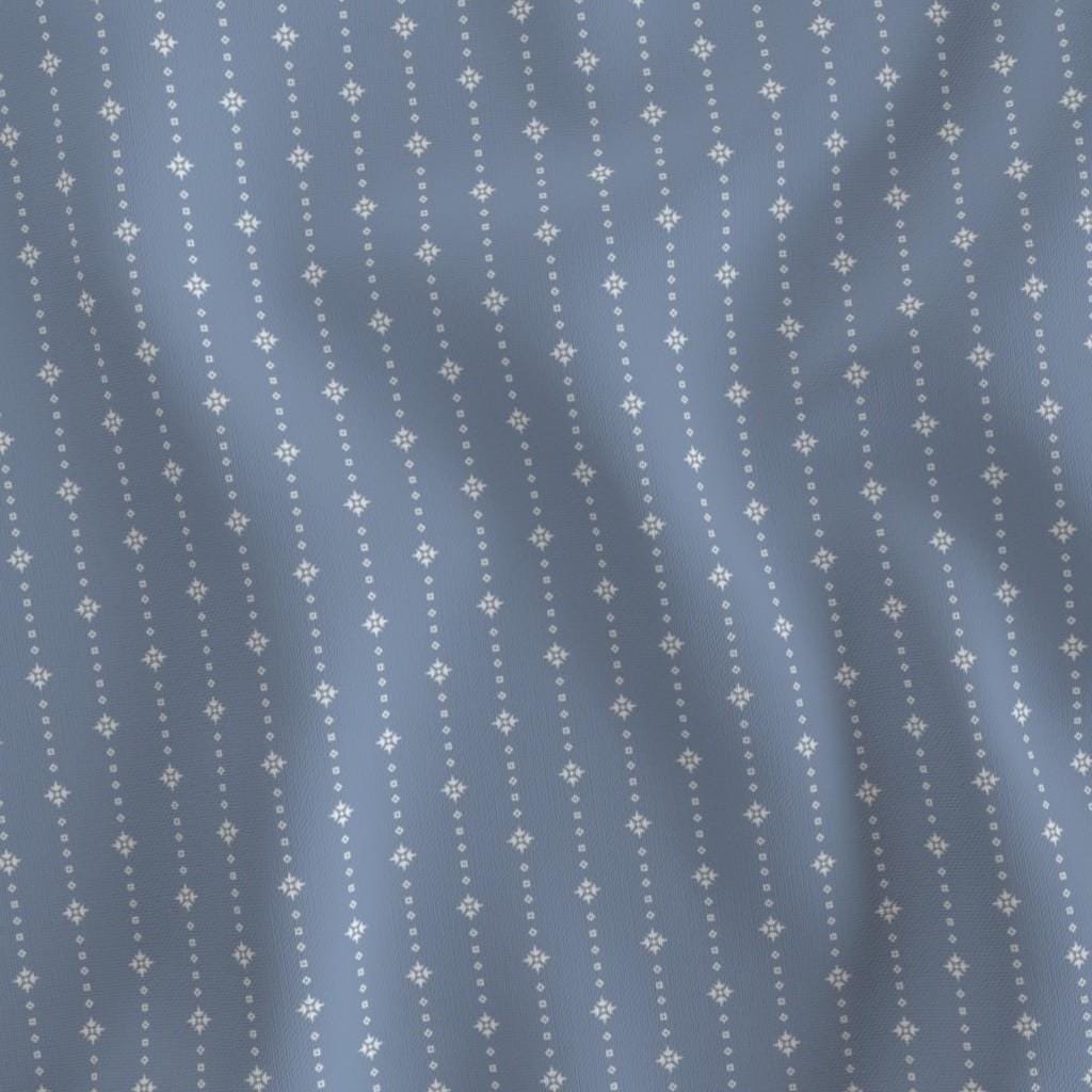 Ivory on Blue ditsy star stripe fabric draped to show the soft hand and ivory star stripe on a soft blue ground print