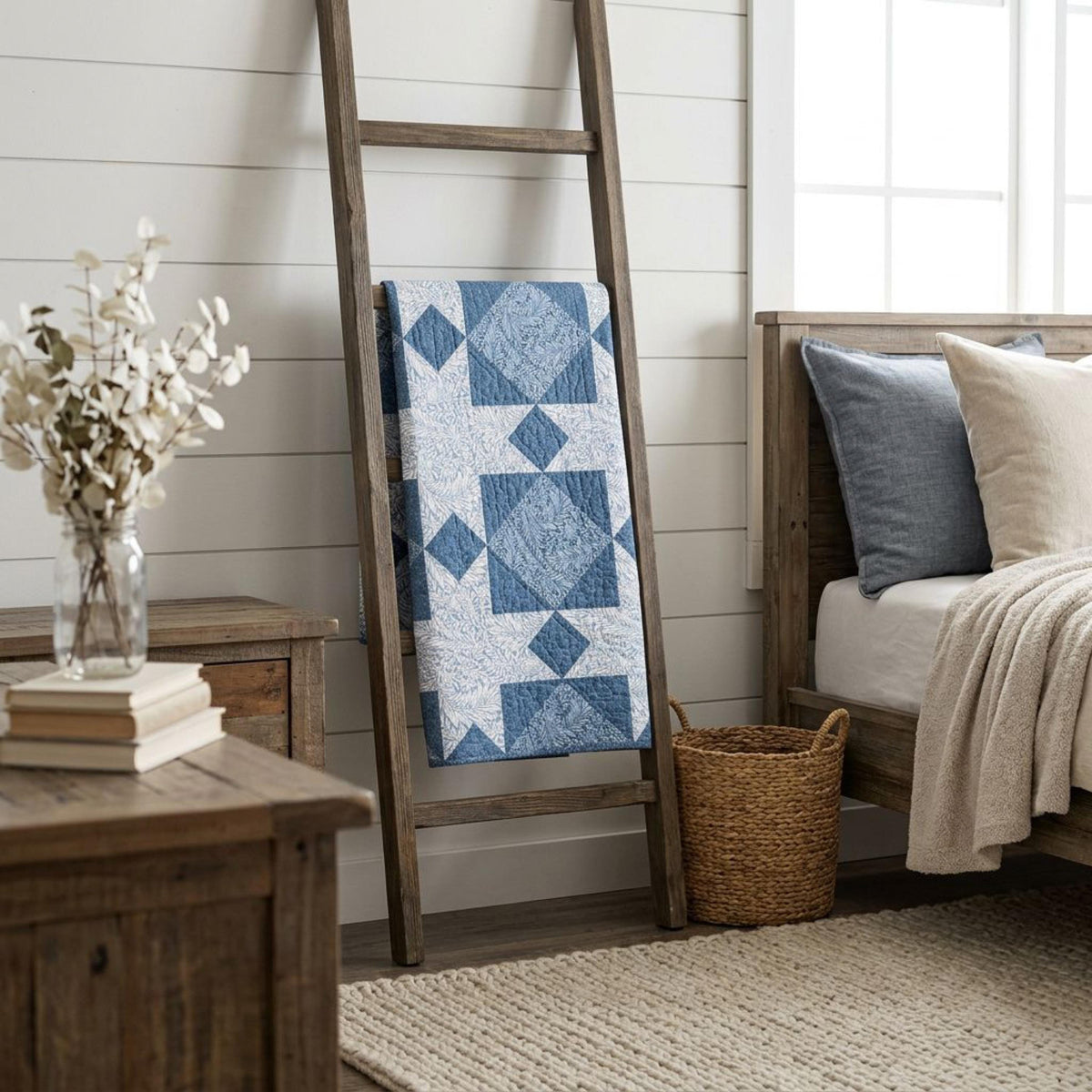 Finished blue star quilt on a blanket ladder in a cottage bedroom