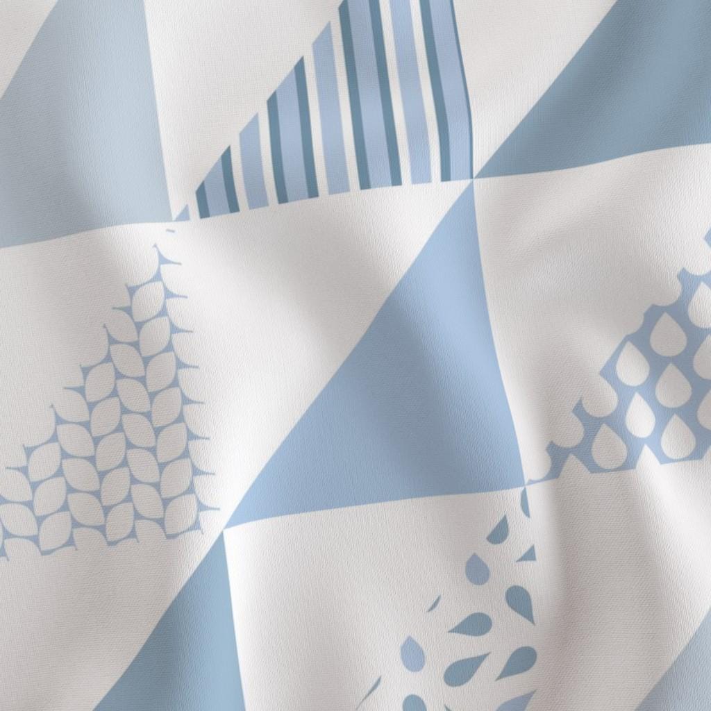Close-up of soft blue geometric half-square triangle blocks on quilting cotton