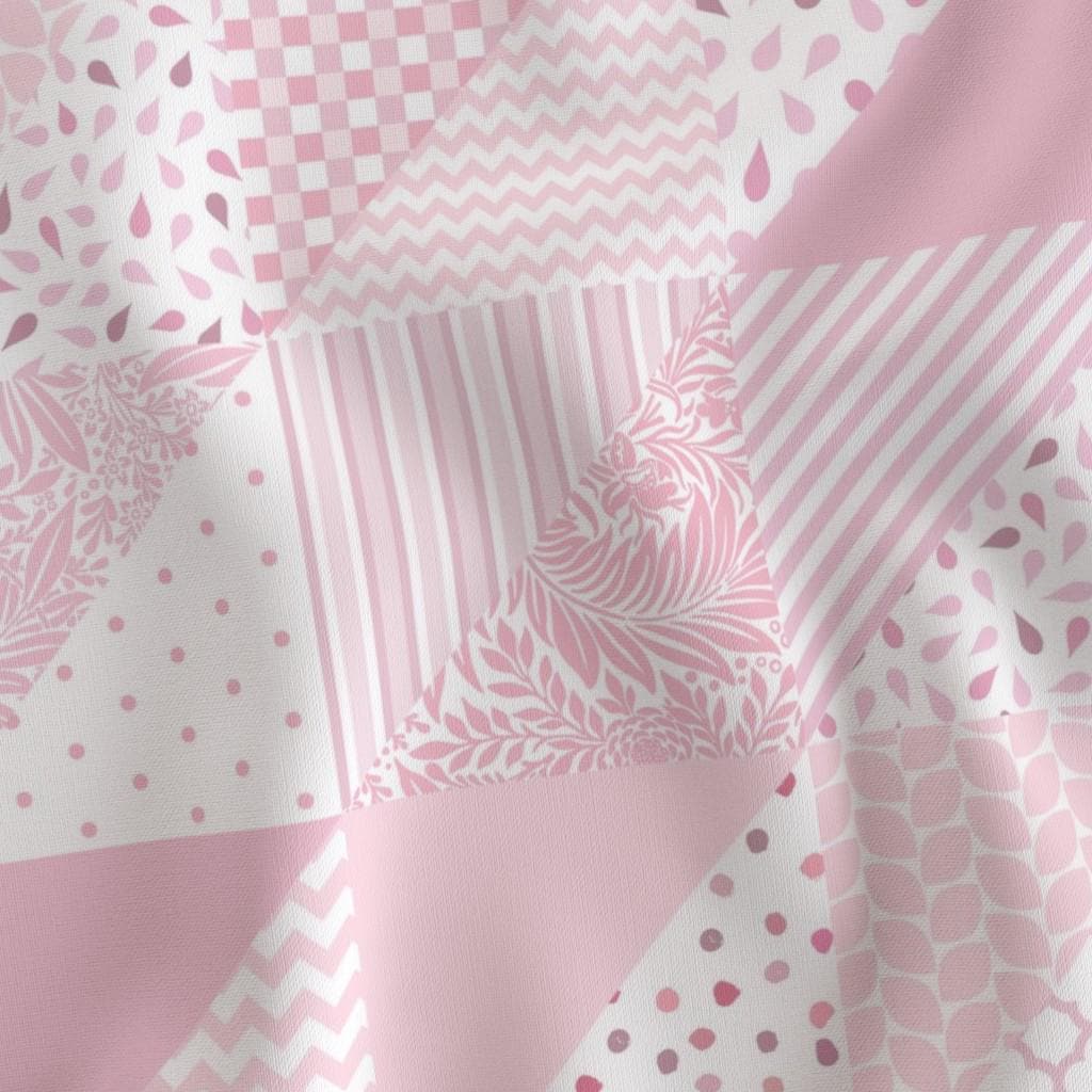 Close-up of pink faux patchwork quilting cotton with geometric, stripe and dot blocks