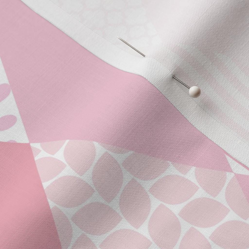 Close-up of pink geometric diamond patchwork with coordinating floral and stripe prints