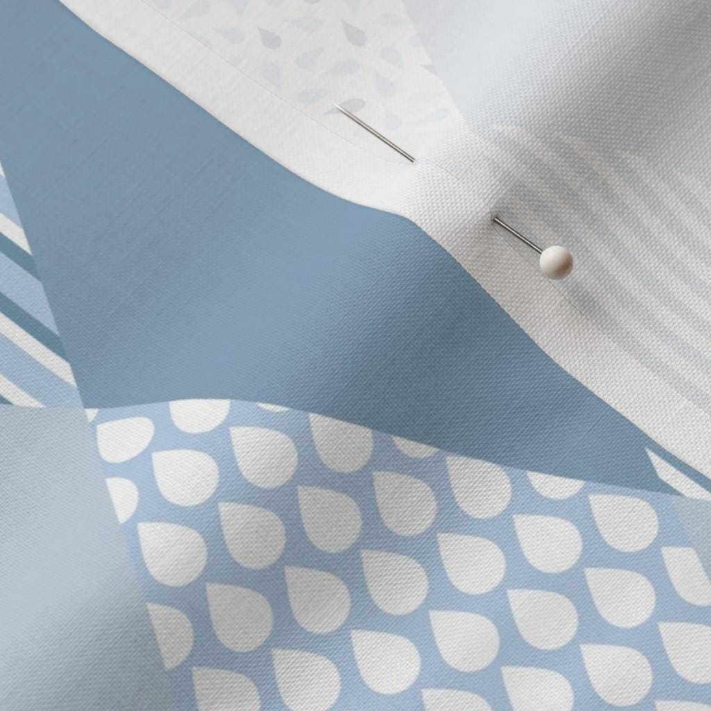 Close-up of blue diamond baby fabric with stars, stripes, dots and geometric prints