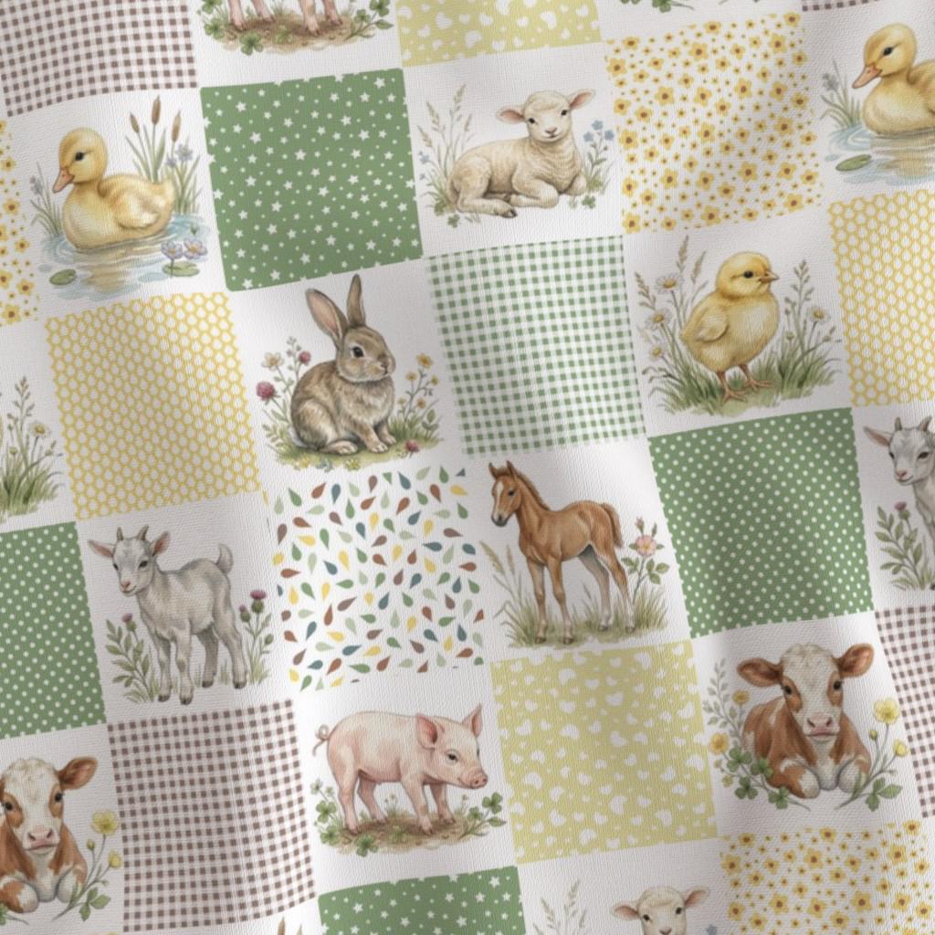 Close-up of printed quilt blocks with a baby lamb, piglet, calf and duckling