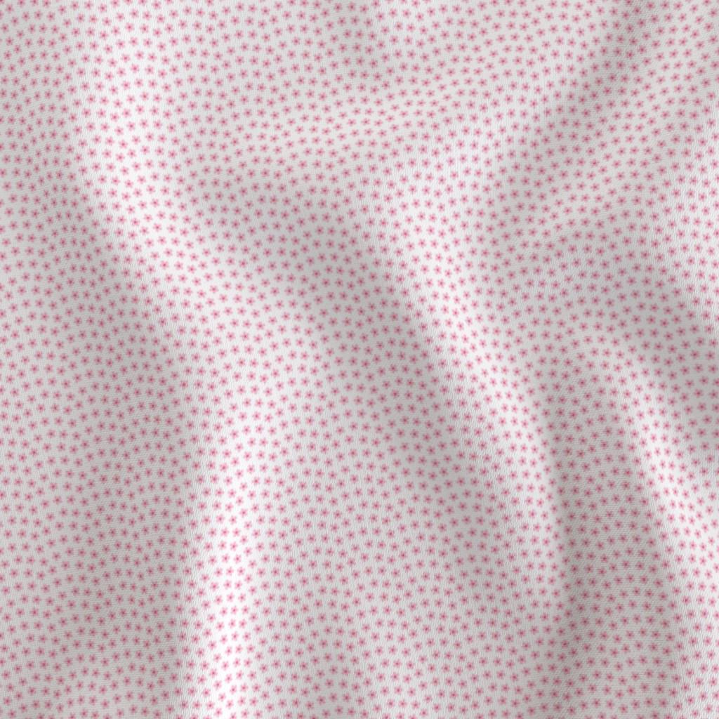 Pink ditsy floral fabric showing the tiny flower print on cotton quilting fabric
