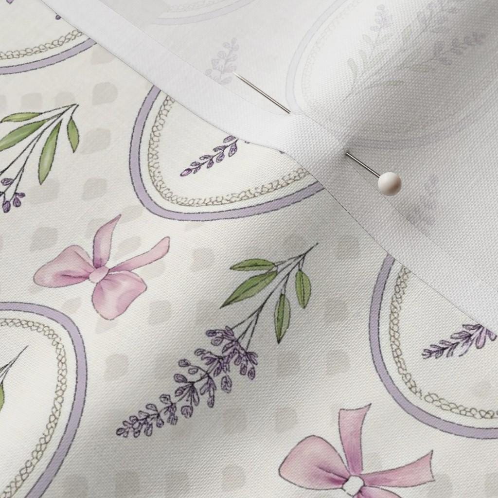 Close-up of geese, lavender sprigs, bows and soft stripes on the baby quilt panel