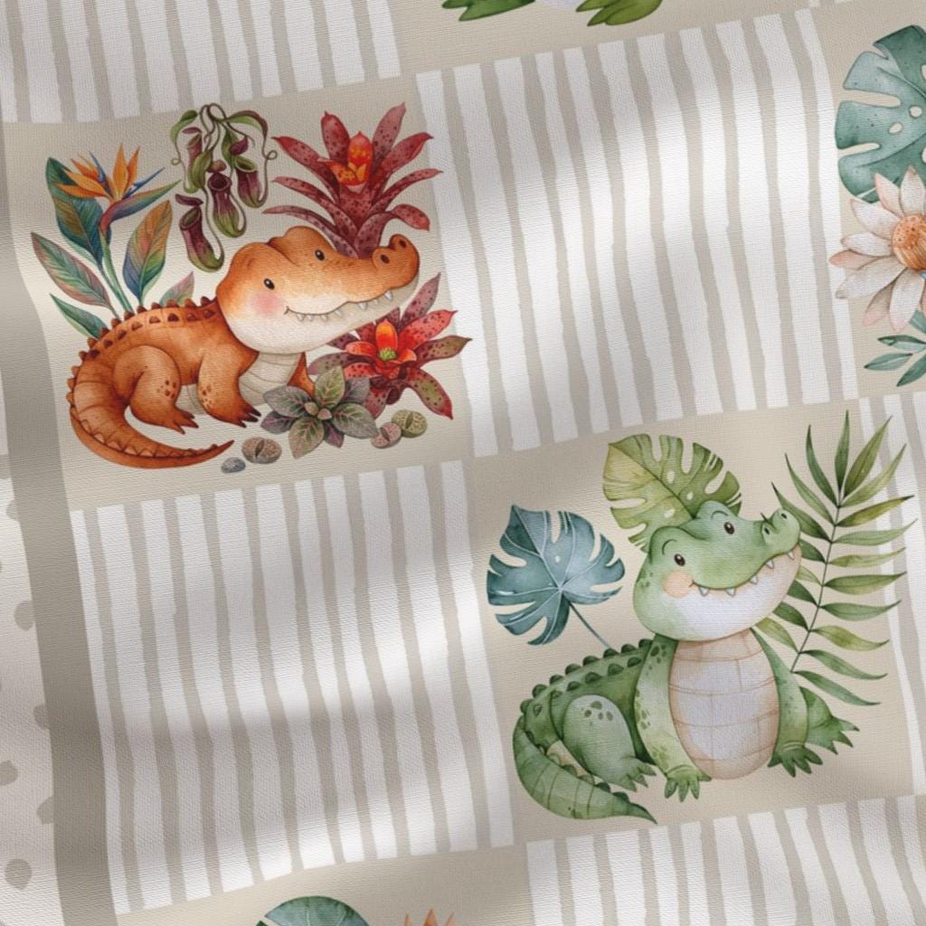 Close-up of watercolor baby alligators and neutral stripes on quilting cotton
