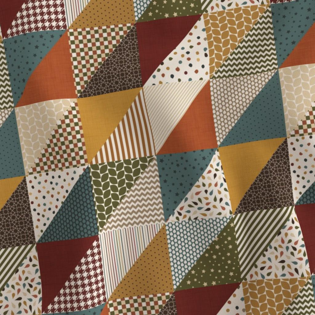 Close-up of diagonal geometric blocks with autumn-inspired prints on quilting cotton