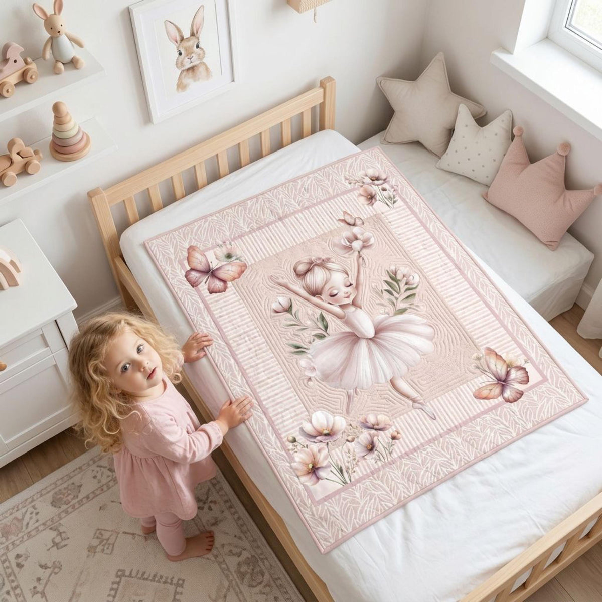 Toddler girl holding a finished ballerina nursery quilt made from the panel