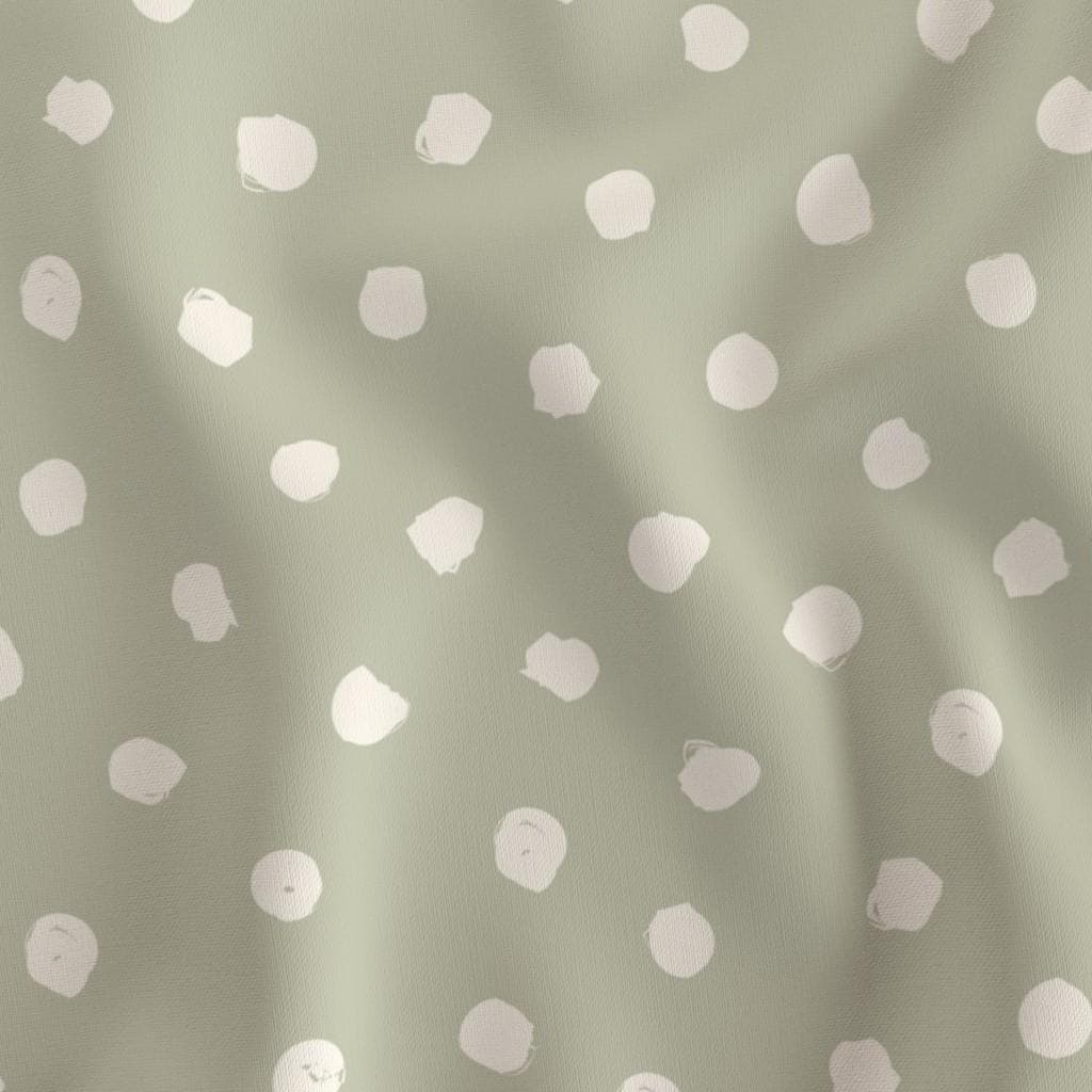 Close-up of Sage Dots fabric with large hand-drawn ivory dots on muted sage