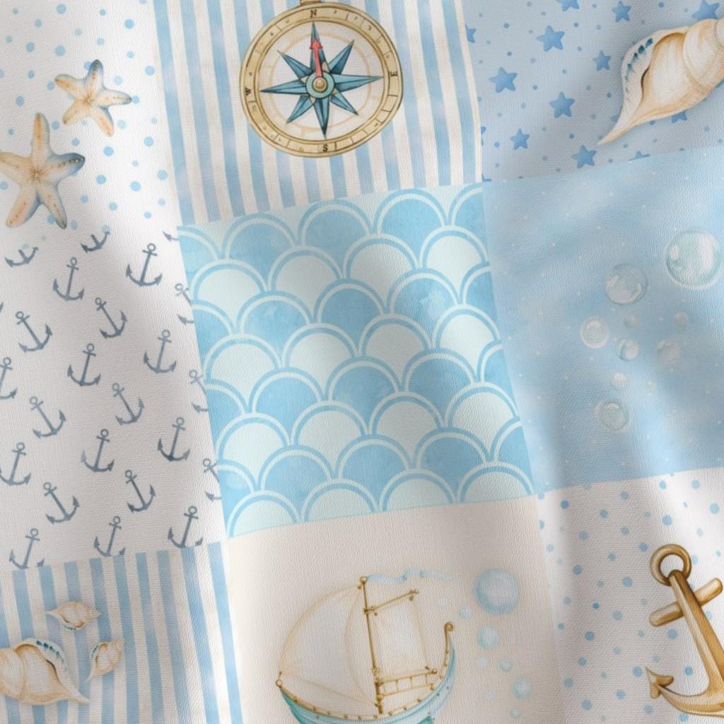 Close-up of blue nautical print with sailboats, anchors, compasses and waves on quilting cotton